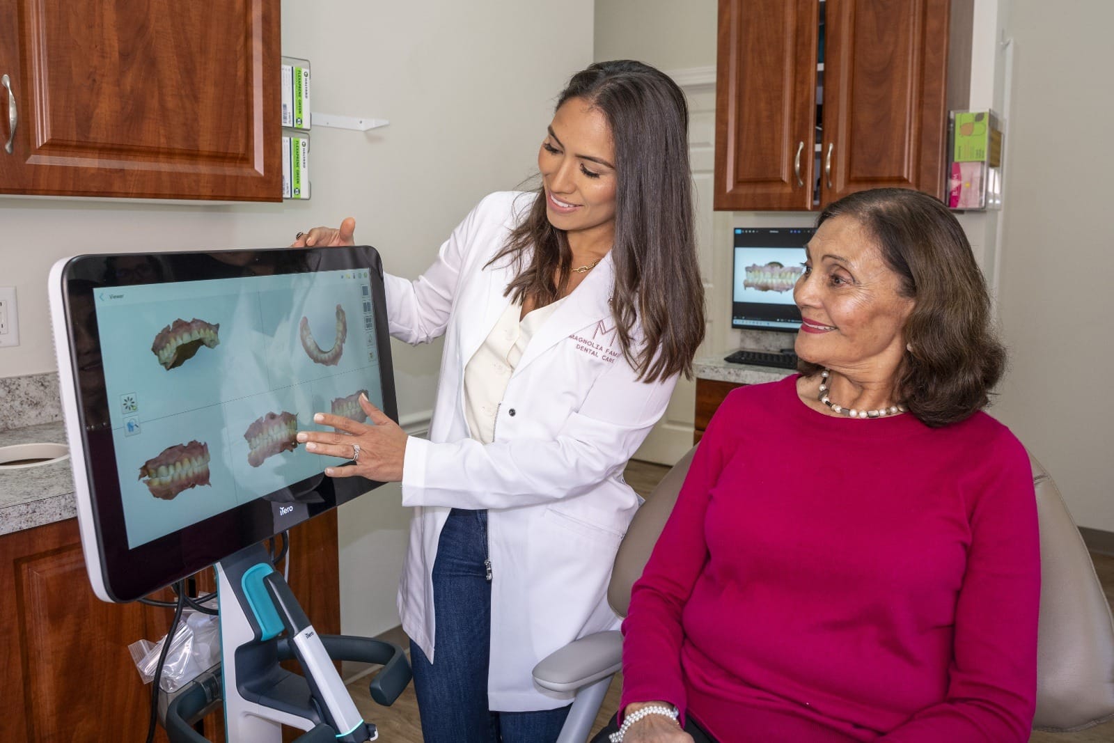 Dr. Rodriguez showing a patient some dental scans