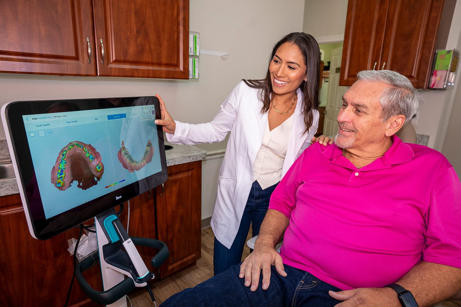 Dr. Rodriguez showing a patient some scans on a iTero scanner