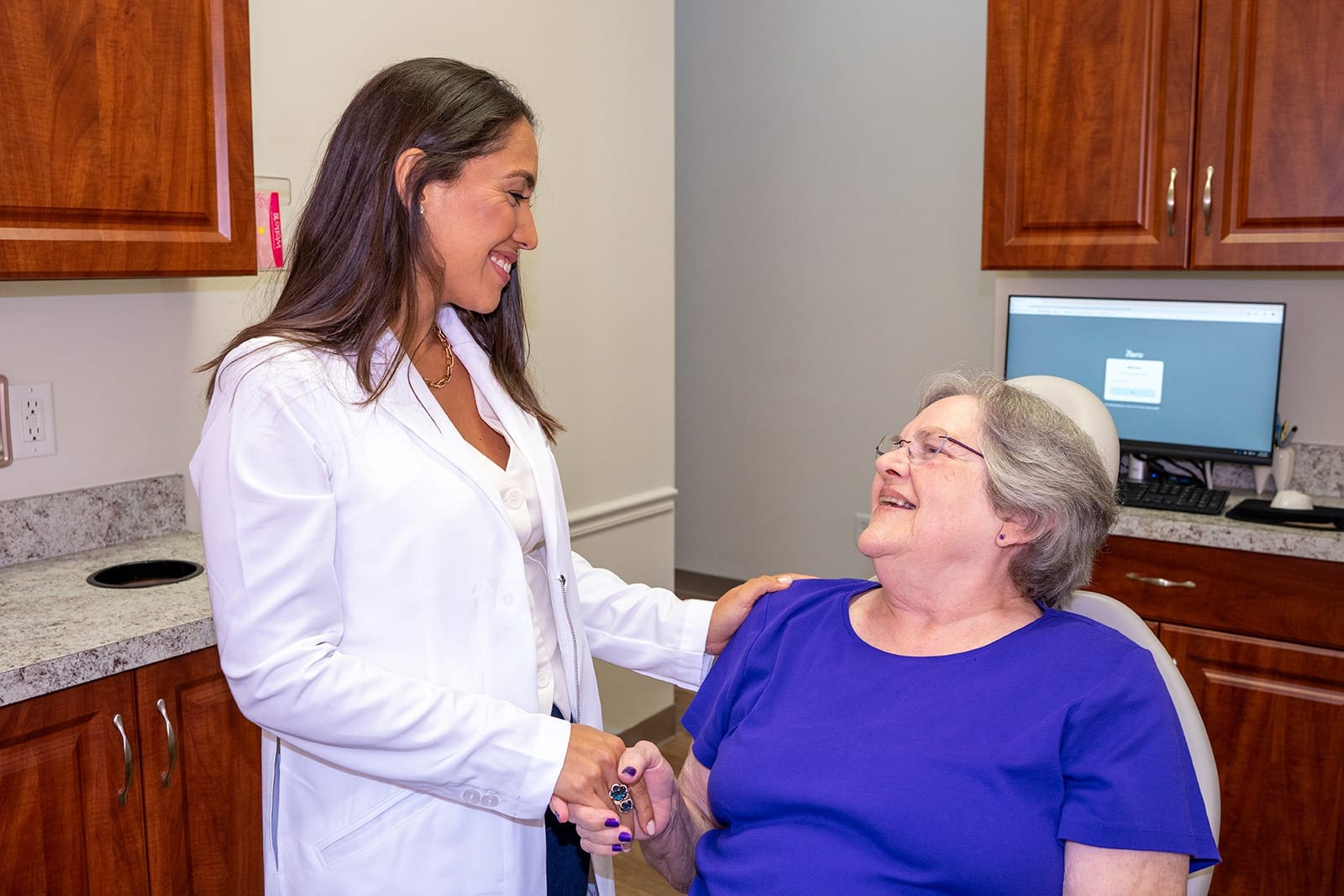 Dr. Rodriguez shakes hands with a patient before a procedure