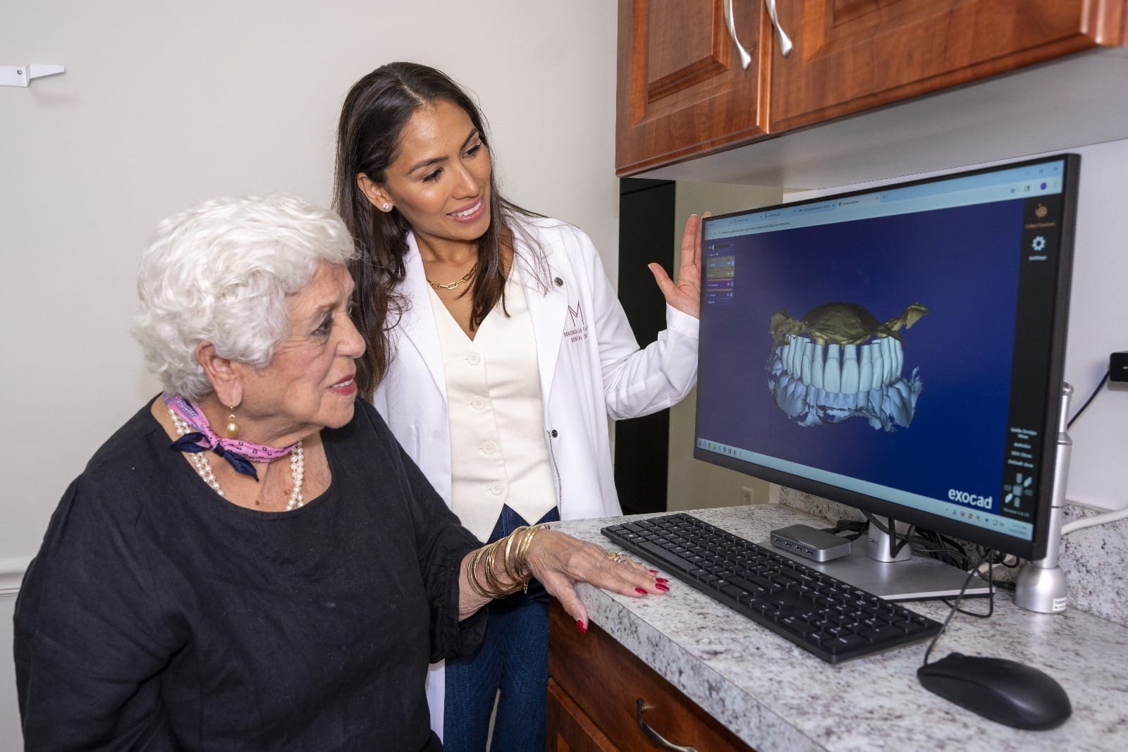 Dr. Rodriguez shows a patient a dental scan