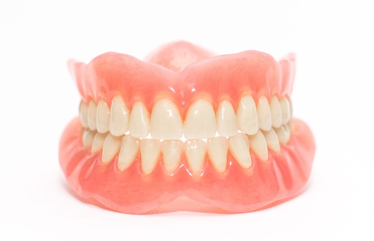 Two acrylic dentures ,white background.
